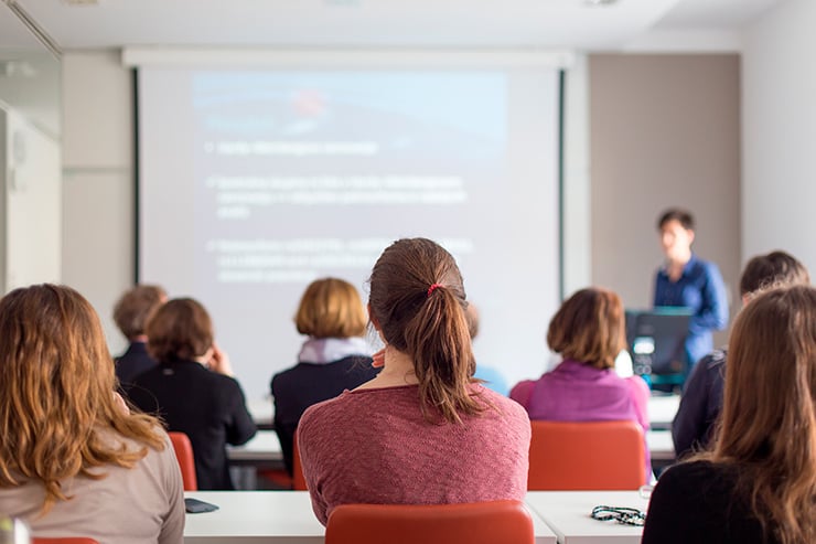 Una mujer realiza un presentación en PowerPoint durante un curso de formación