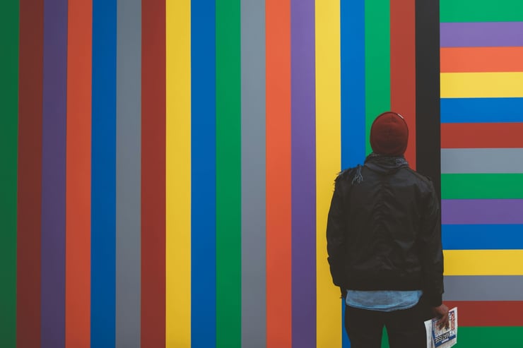Un hombre contempla una obra de arte en la que destacan los colores y las líneas